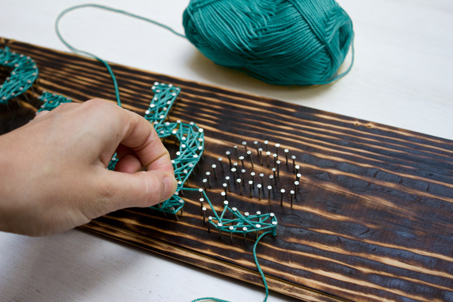 Make yourself a typography inspired DIY string art sign with just a few easy steps.